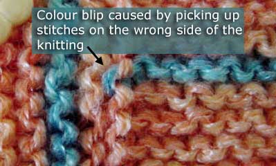 Colour blip caused by picking up stitches on the wrong side of the row