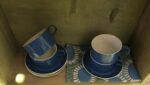 Blue and white teacups. I love the white stripe on the cups combined with the floral tea towel
