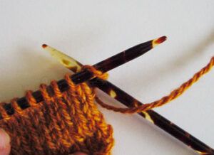 Working a yarn over at the beginning of a row before a knit stitch. Diagram 1