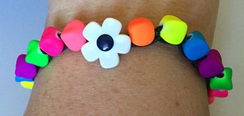 Beaded rainbow loom bracelet with a button closure