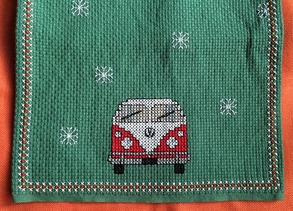 Cross stitch Christmas table runner with VW vans and snowflakes on vintage binca fabric.