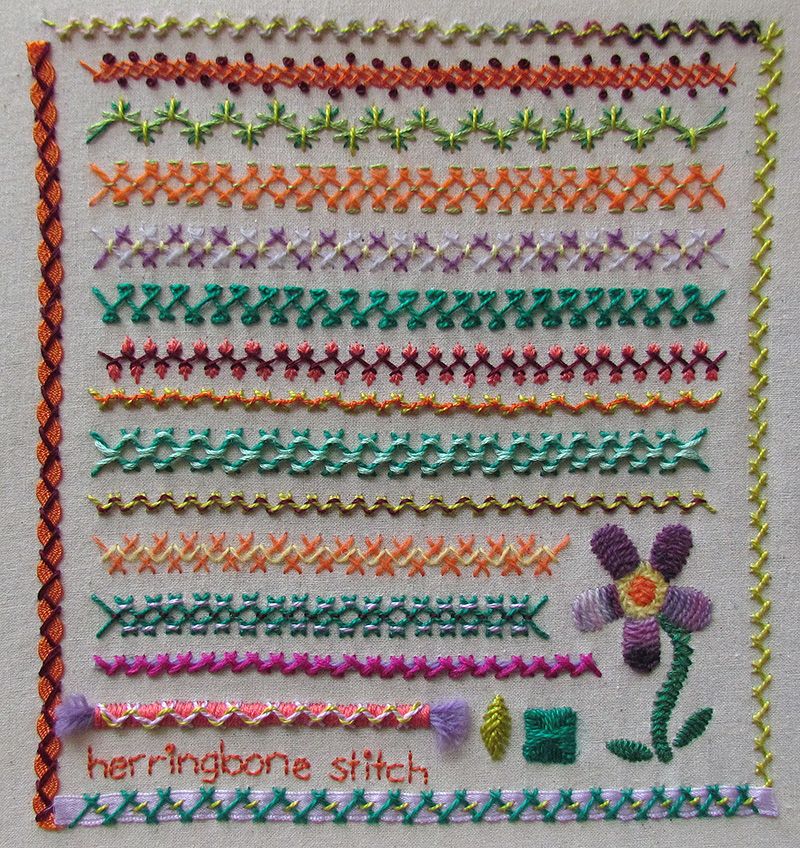 Embroidered sampler in herringbone stitch with flower and decorative borders