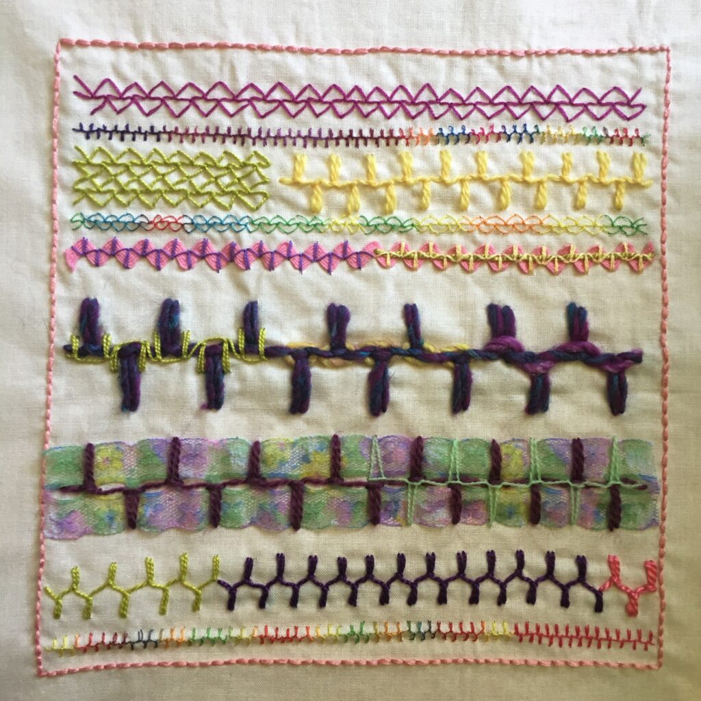 Embroidery sampler on calico featuring alternating up and down buttonhole stitch.