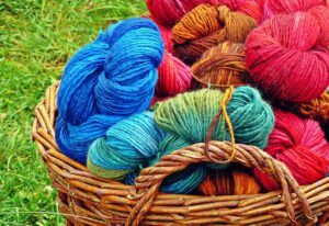 Balls of brightly coloured yarn in a basket