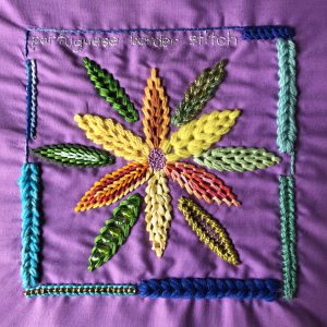 Portuguese border stitch worked in a flower shape using a variety of threads.