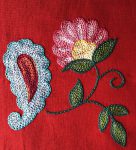 Flower and paisley embroidered with chain stitch filling.