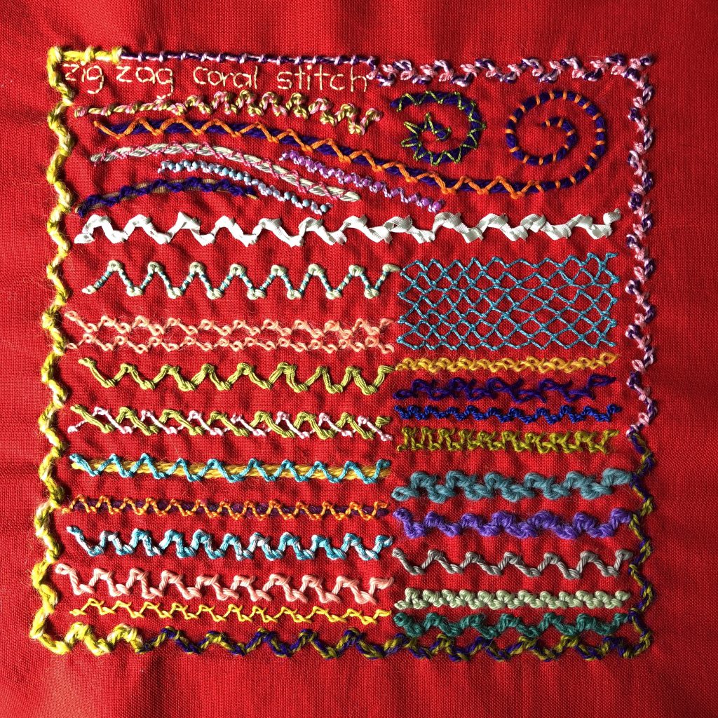 Zig-zag coral stitch worked in a variety of threads on red even weave fabric.