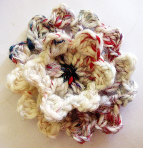 A custer stitch crochet flower made on a loom