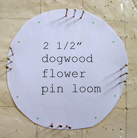 A dogwood flower loom made with pins