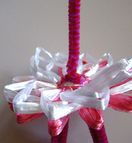 Winding a doll on a flower loom