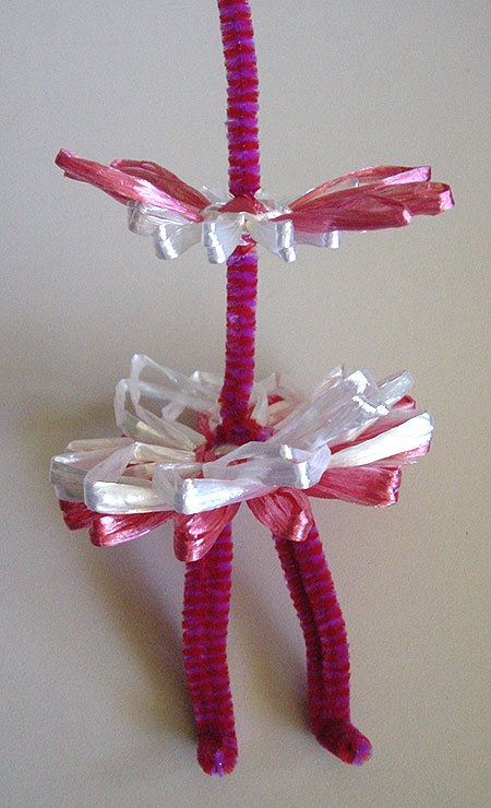 Winding a doll on a flower loom