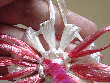 Winding a doll on a flower loom