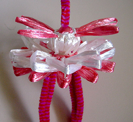 Winding a doll on a flower loom