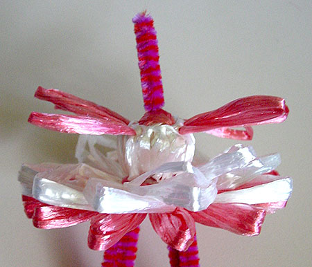 Winding a doll on a flower loom