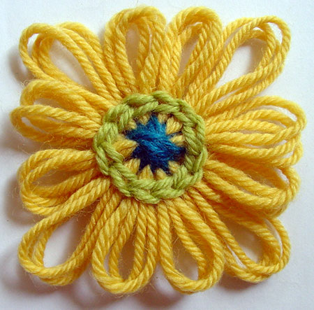 The finished yarn flower with a round of chain stitch worked.