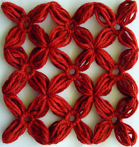 Nine yarn flowers joined together