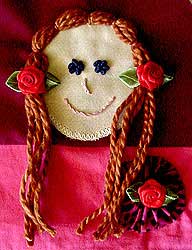 Red doll with couched har and rose barettes