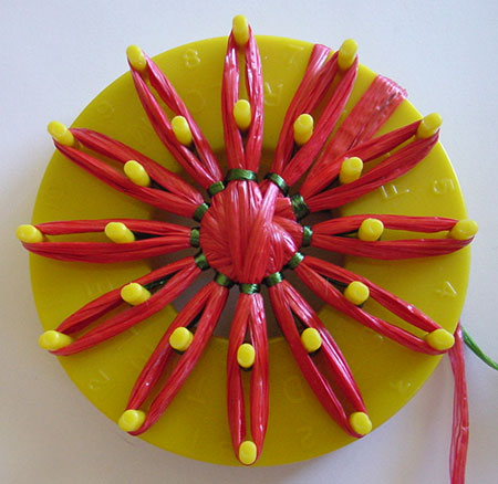 Red swisstraw flower on a multe-fleur loom