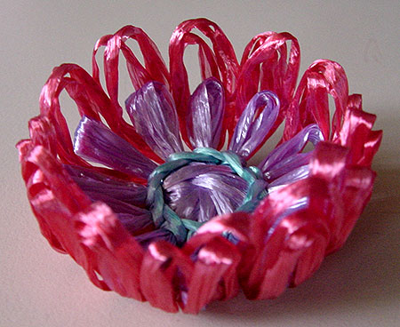 A bowl shaped raffia flower