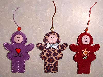 Three flat Betsy doll Christmas decorations