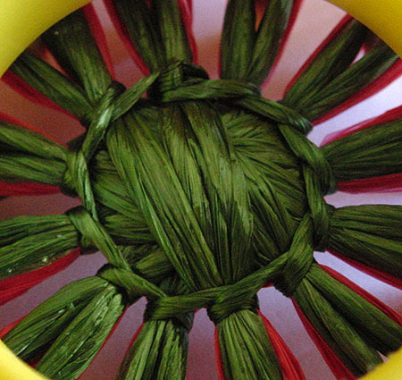 Stitching a strawberry on a flower loom