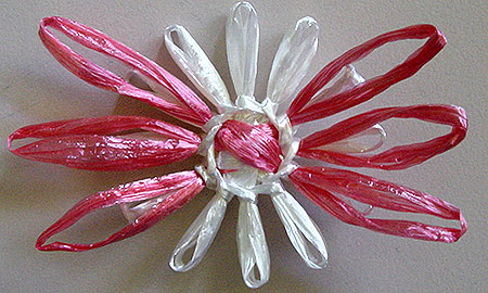 Winding a doll on a flower loom