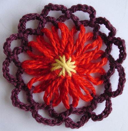 Yarn flower with a star stitch center