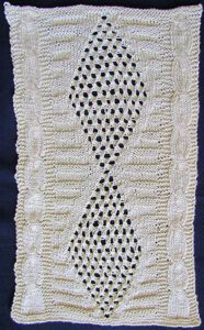 Cabled and lace afghan strip with eyelet diamonds in the centre