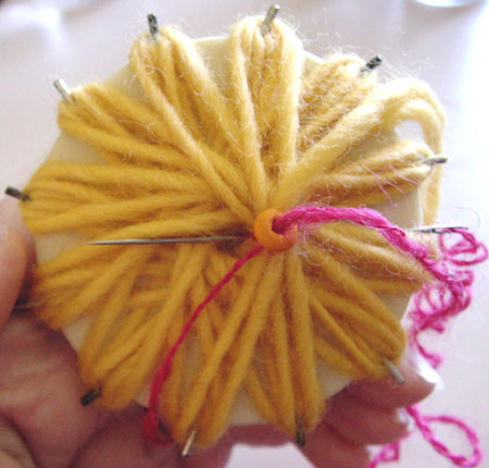 Making a beaded flower on a flower loom