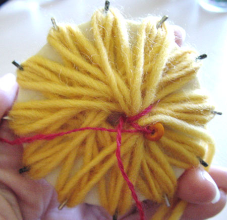 Making a beaded flower on a flower loom