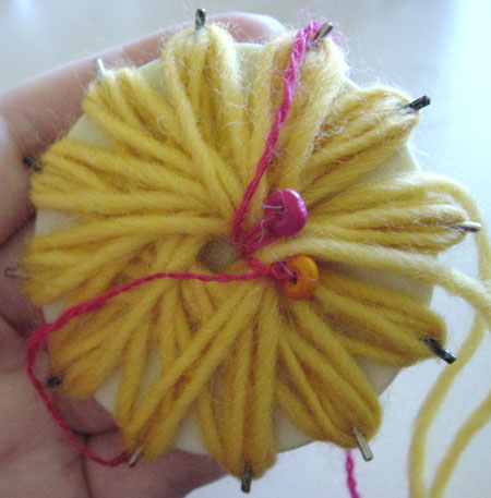 Making a beaded flower on a flower loom