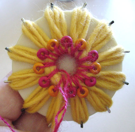 Making a beaded flower on a flower loom