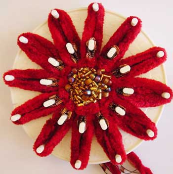 The finished flower on the loom