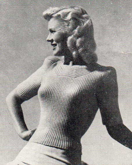 Fitted, garter stitch rib lady's jumper with neckline detail, and puffed sleeves. 