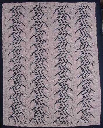 Rectangular knitted doily with coral lace patterning