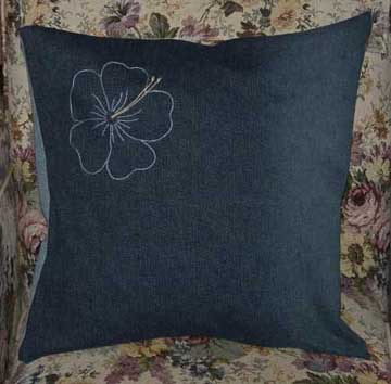 Denim cushion with hand embroidered hibiscus flower