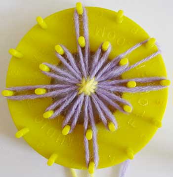 Diamond shaped yarn flower on a loom