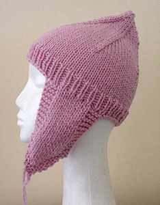 Pink knitted hat with earflaps