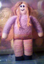 Knitted doll with lavender mohair shirt and pink variegated pants