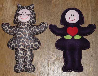 Two dolls with a line sewn to separate the legs