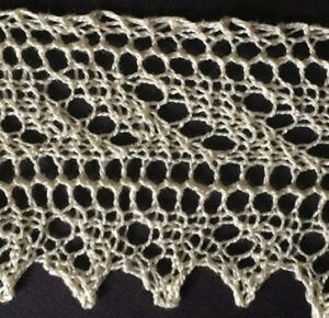 KNitted lace edging with diagonal stripes and saw tooth edge
