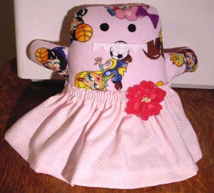 Soft toy monster in a pink flowery skirt