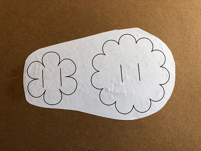 Paper flower templates stuck onto scrap cardboard