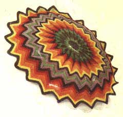 Striped crochet cushion cover in a sunburst design