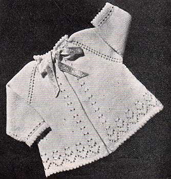 raglan baby jacket with picot edging, long sleeves and lace patterning.
