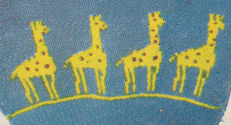 Dtail of giraffe pattern with placement of spots and eye in duplicate stitch embroidery