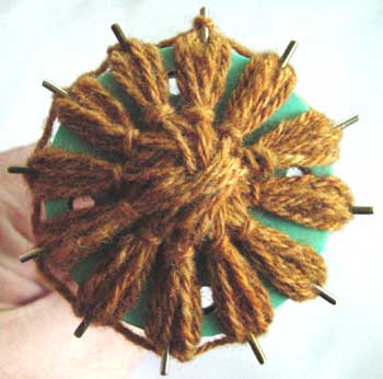 Loomed flower with knots worked on nine petals