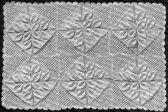 Baby blanket made up of 24 individual squares with a crochet border and embossed leaf design