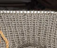 Knit 1, purl 1 ribbing on a knitting needle.