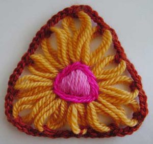 A flower made on a triangular flower loom